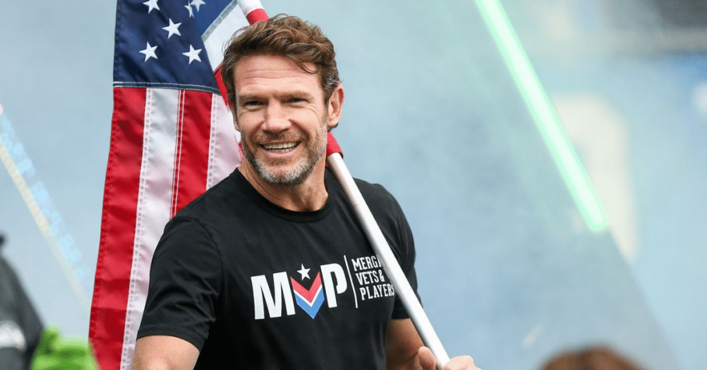 image of Nate Boyer holding Flag