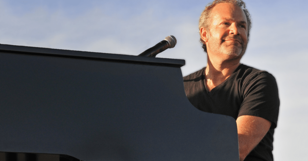 image of Five for Fighting singer sitting at a piano